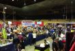 Dayton Hamvention show floor with vendors displaying ham radio equipment and participants exploring gear and treasures.