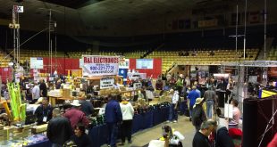 Dayton Hamvention show floor with vendors displaying ham radio equipment and participants exploring gear and treasures.