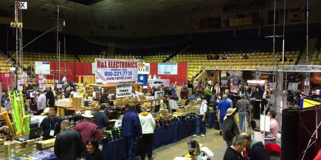 Dayton Hamvention show floor with vendors displaying ham radio equipment and participants exploring gear and treasures.